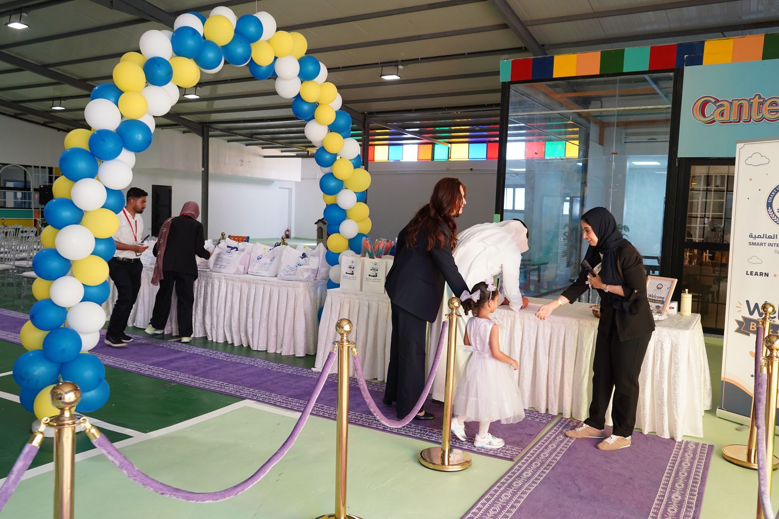 Staff welcoming a family at the registration table